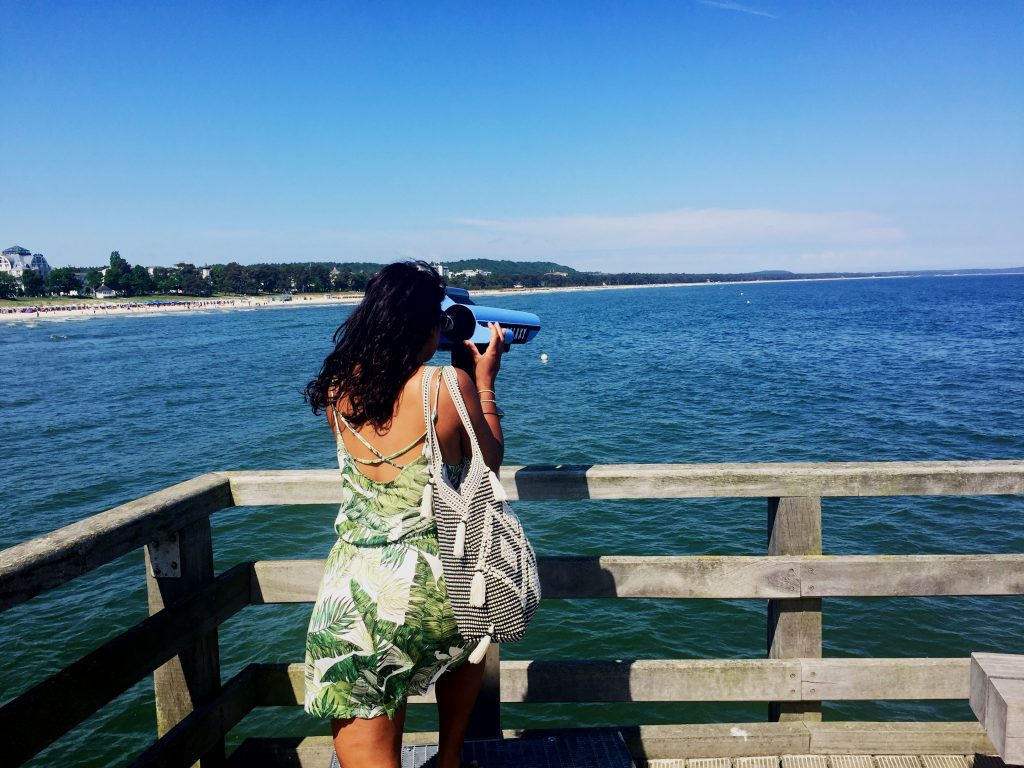 Absolutely Lucy looks through binoculars at sea