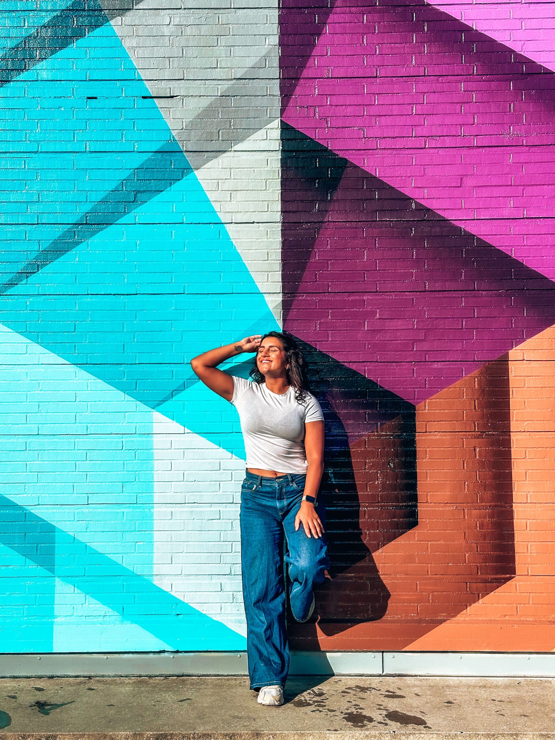 Girl stands sassily in front of street art mural in Rotterdam while exploring The Perfect 3 Day Rotterdam Itinerary For First-Timers